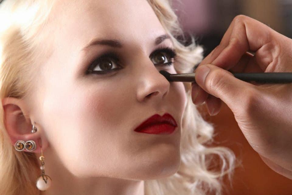 essional makeup artist applying foundation in Seattle studio